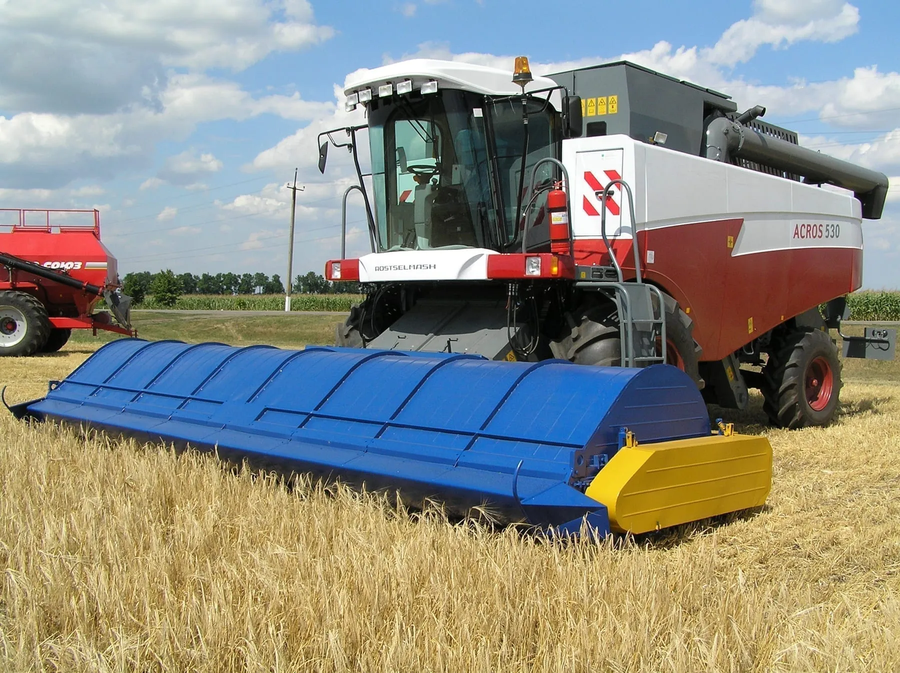 ACROS 530 с двухбарабанной очёсывающей жаткой «Славянка УАС»